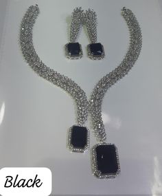 Faux CZ Diamonds Black Necklace Earrings, Bridal Dangler Earrings, Bridal Choker, Party Wear Silver Necklace Earrings, Statement Piece ITEM DESCRIPTION Metal        = Silver Plated Occasion  = Wedding, Party Wear, Bridal Color        = White and Black Size          = Necklace Length = 7 Inches Long, Earring Size = 2.5 Inches Long,  Free Shipping 100% Satisfaction Guarantee: 1 Year Warranty, Long Lasting Plating, High-Quality Stones Occasion: Perfect choice for any Indian occasion.  Care: It is a Elegant Black Dangle Jewelry Sets, Black Jewelry Sets For Party, Glamorous Hand Set Jewelry For Party, Black Cubic Zirconia Jewelry For Party, Black Cubic Zirconia Necklace For Party, Black Wedding Jewelry With Jewels, Elegant Black Jewelry Sets With Matching Earrings, Elegant Black Necklace For Celebration, Black Glamorous Jewelry For Formal Occasions