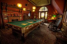 an old fashioned pool table in the middle of a room