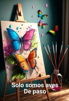 an easel with paint and some butterflies on it