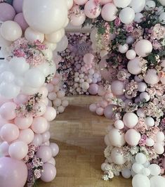 a room filled with lots of balloons and flowers