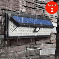 an image of a solar powered wall light on the side of a brick building in the rain