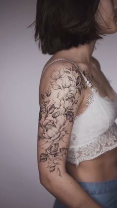 a woman's arm with flowers on it and the word tattoo written in russian