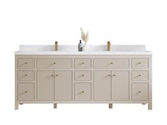 a bathroom vanity with two sinks and gold faucets