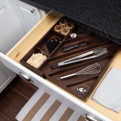 an organized drawer with utensils in it