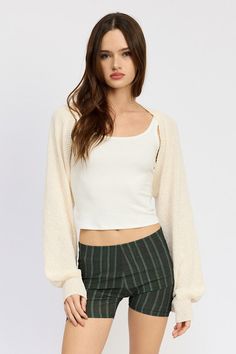 This imported Blouson Sleeve Bolero is made from 40% acrylic, 40% polyester, and 20% artificial hemp. The model wears a size small with a height of 5'9. Comfortable and stylish, it adds a touch of elegance to any outfit. Chic Stretch Shrug For Fall, Trendy Fitted Knit Outerwear, Trendy Knit Fitted Outerwear, Casual Knit Stretch Shrug, Fitted Soft Knit Cotton Outerwear, Fitted Casual Spring Shrug, Long Sleeve Cotton Shrug For Fall, Casual Stretch Winter Shrug, Casual Winter Stretch Shrug