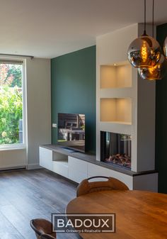 a living room filled with furniture and a flat screen tv on top of a wooden table