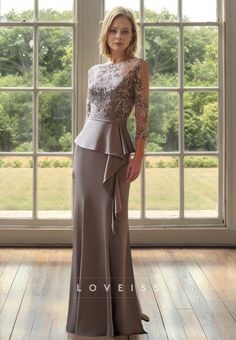 a woman standing in front of a window wearing a dress with lace on the top