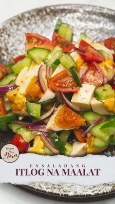 a salad with tomatoes, cucumbers, onions and other vegetables on a plate