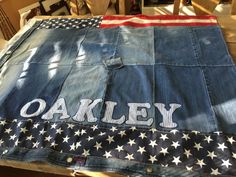 an old jean jacket with the word oaky painted on it and american flag in the back