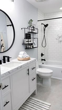 a white bathroom with black and white accessories