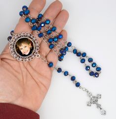 "Lovely blue rosary beaded with blue iridized lightweight glass crystals, make it personal with your image, saint, saying, great for a memorable gift. .  traditional 5 Decade or Dominican Rosary This is not a paper photo and does not have heavy glass, it is created with special dyes on a high definition metal for amazing color, clarity, and long lasting waterproof color. sure to become a favorite . hand crafted by our family we do not send your image out. this way we can guarantee quality and fast service..  I personally work with your image and always send a proof so you get the final say before we complete your order.  I send proofs within 24 hrs. and once approved and purchased we ship within 3 days. many times sooner.  an amazing personal gift sure to become a family keepsake. Mothers, Personalized Blue Round Beads Jewelry For Gift, Blue Round Beads Jewelry For Personalized Gift, Personalized Blue Beaded Jewelry, Blue Spiritual Rosary As A Gift, Blue Healing Rosary, Spiritual Blue Rosary With Gemstone Beads, Blue Rosary With Round Beads For Gift, Wedding Communion, Beads Gifts