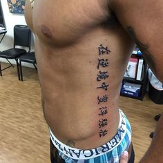 a man with chinese writing on his stomach