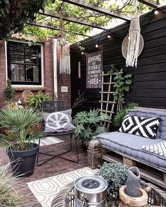 an outdoor seating area with wicker furniture and plants