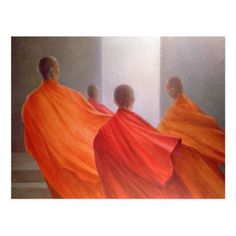 three monks in orange robes are looking at the light coming from behind them on a white wall