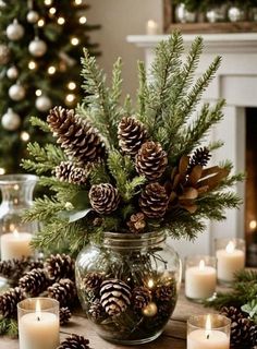 a table topped with pine cones and candles