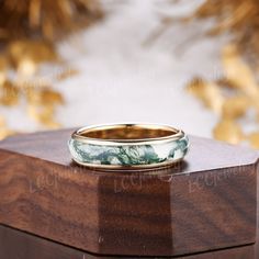 a wooden box with a wedding ring on it