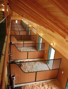 the inside of a building with wooden walls and flooring is lit up by lights