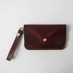 The wristlet clutch is our most versatile leather clutch, with plenty of space for your cards, keys, and phone. It's made of the same beautiful full-grain leathers as our bestselling leather tote bags and can be embossed with your initials at no additional charge. The clutch measures 8.5 inches by 5.25 inches and comes standard with a 5.5-inch wristlet strap, which is permanently affixed to a D-ring on one side of the clutch. Alternately, you can customize your clutch to wear it as a small cross Leather Clutch With Wrist Strap For Daily Use, Leather Wallet With Wrist Strap, Daily Use Leather Clutch With Wrist Strap, Leather Clutch Wallet With Wrist Strap, Leather Wristlet With Cell Phone Pocket For Daily Use, Classic Clutch With Wrist Strap For Everyday Use, Leather Wristlet With Cell Phone Pocket, Classic Everyday Clutch With Wrist Strap, Everyday Clutch With Wrist Strap