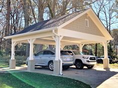 two cars are parked in the driveway under a covered carport on a sunny day