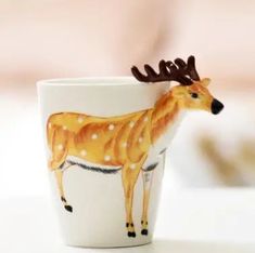 a cup with a deer painted on it