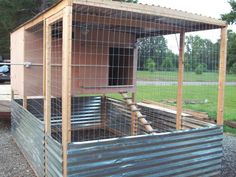 an outdoor chicken coop made out of metal and wood