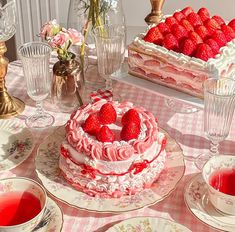 there is a cake with strawberries on it and other desserts in the background