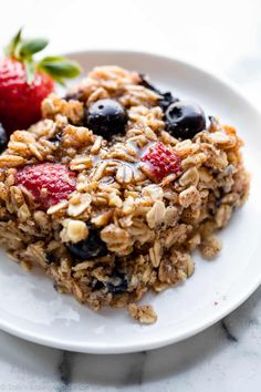 a white plate topped with granola and fruit