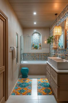 a bathroom with blue and orange tiles on the floor next to a bathtub, toilet and sink