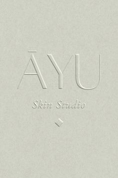 the logo for ayi skin studio is shown in white and gray colors on a light grey background