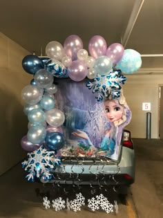 the back of a car decorated with balloons and snowflakes for frozen princess birthday party