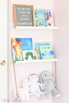 two white shelves with books and stuffed animals on them