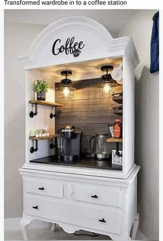 the coffee station is built into an old cabinet with lights on top and below it