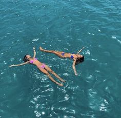 two women are floating in the water together