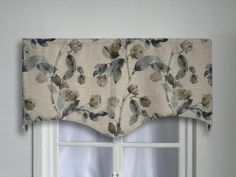 a window with a flowered valance hanging from it's side