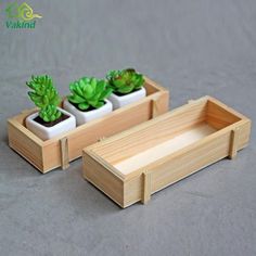 three wooden planters with succulents in them