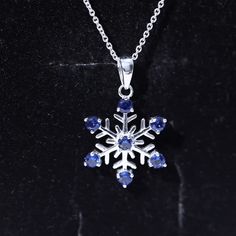 Product Details Delight your beloved with a heartfelt surprise: This enchanting piece features a delicate snowflake design adorned with Round Cut Created Blue Sapphire, carefully set in a prong setting. The captivating blue hue of the created sapphire adds a touch of elegance and charm to this beautiful necklace, making it a truly enchanting gift for your special lady. Let this Snowflake Necklace be a symbol of your love and appreciation, celebrating the uniqueness and beauty of your relationship. Product Information SKU SHP-PENDANT042168124 Weight 3.36 gm (Approximate) LAB CREATED BLUE SAPPHIRE INFORMATION No.of Stones 7 Pieces Total Weight 1.05 Carat (Approximate) Dimension(approx) Round-3X3 mm-7 Pcs Color Blue Cut Brilliant Shape Round Setting Type Prong-Setting Quality Grade AAAA View Sapphire Pendant Jewelry Gift, Sapphire Pendant Jewelry With Stones, Sapphire Round Pendant Jewelry For Gift, Snowflake Pendant Necklace, Winter Snowflake Necklace, Perfect For Gifts, Simple Snowflake, Blue Sapphire Pendant, Snowflake Necklace, Snowflake Pendant