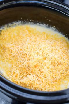 cheese is being cooked in the crock pot