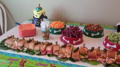 a table topped with lots of food and desserts