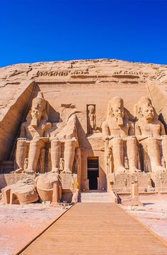 the entrance to an ancient egyptian temple with statues