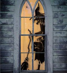 an image of a stained glass window with a scarecrow holding a broom in front of it