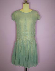 "Beautiful 1920s silk chiffon beaded dress in a light blue color. Has a scoop neckline, cap sleeves, and flutter skirt which is created by diamond shaped beaded and rhinestone vertical embellishments. Condition: very good vintage condition. Has one tiny mend where there is an intersection of two diamonds. Has a small stain on the bodice and at the armpits which I have not attempted to clean Quite minor. Label: none Circa: 1920s Composition: silk Color: blue Size: small Measurements: Shoulder str 1920s Embellished Summer Dresses, 1920s Style Embellished Summer Dresses, Embellished 1920s Style Summer Dresses, Fitted Art Deco Summer Dress, Summer Flapper Style Beaded Dresses, 1920s Style Summer Flapper Dress, Fitted Blue Flapper Dress For Summer, 1920s Beaded Fitted Dress, 1920s Fitted Beaded Dress