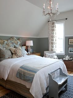 a bedroom with a chandelier hanging from the ceiling and a bed in it