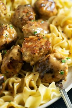 a white plate topped with meatballs and pasta