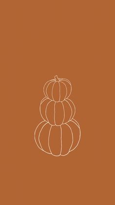 three pumpkins stacked on top of each other in the middle of a brown background