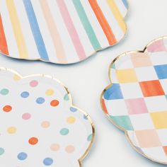 three plates with different designs on them sitting next to each other in the shape of clouds