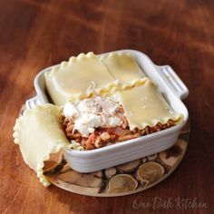 a casserole dish with lasagna and meat in it on a plate