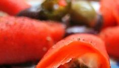 a close up view of some food with tomatoes and other vegetables in the foreground