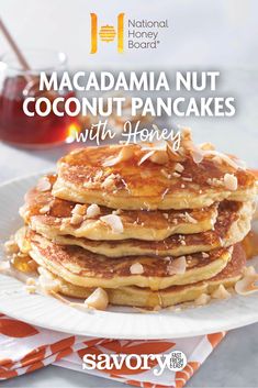 a stack of pancakes topped with nuts and syrup