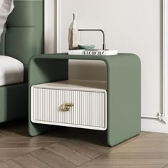 a white and green side table with a magazine on it's shelf next to a bed