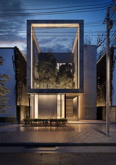 a modern house is lit up at night